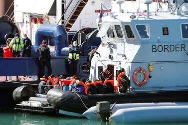 Migrants are brought into Dover port, England, by Border Force officers. Reuters