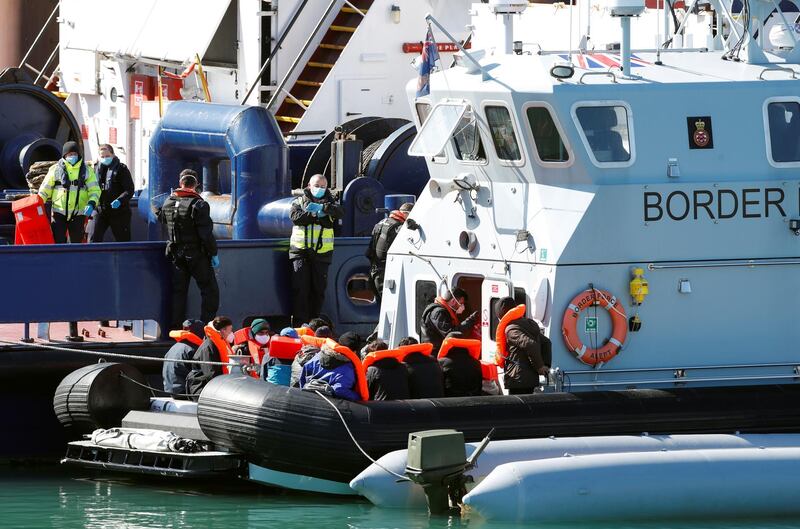 Migrants are brought into Dover Harbour by Border Force officers, in Dover, Britain March 25, 2021. REUTERS/Paul Childs