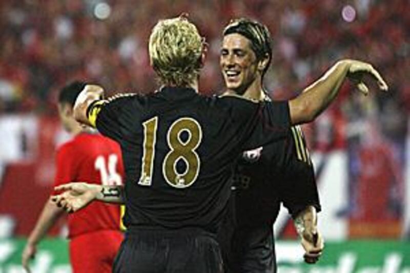 Liverpool strikers Dirk Kuyt, No 18, and Fernando Torres celebrate the fifth goal as the team win in preseason for the first time.