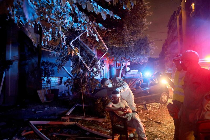 A rescue worker tends to an injured man following an explosion at the port of Beirut.  AFP