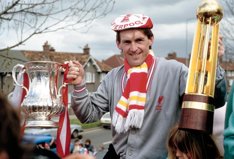 LIVERPOOL, ENGLAND - JUNE 11: Liverpool player manager Kenny Dalglish celebrates with the trophies on the teams homecoming bus parade after completing the Football League and FA Cup double, on May 11, 1986 in Liverpool, United Kingdom. (Photo by Simon Miles/Allsport/Getty Images/Hulton Archive)