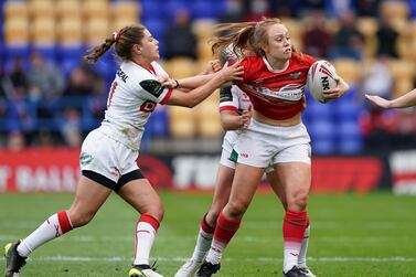 Wales' Seren Gough-Walters (right) tackled by England's Emily Rudge (left) and Amy Hardcastle during the women's international match at the Halliwell Jones Stadium, Warrington. Picture date: Friday June 25, 2021. (Photo by Mike Egerton/PA Images via Getty Images)