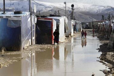 Children wade through floodwaters in Bekaa Valley, Lebanon. Joseph Eid / AFP