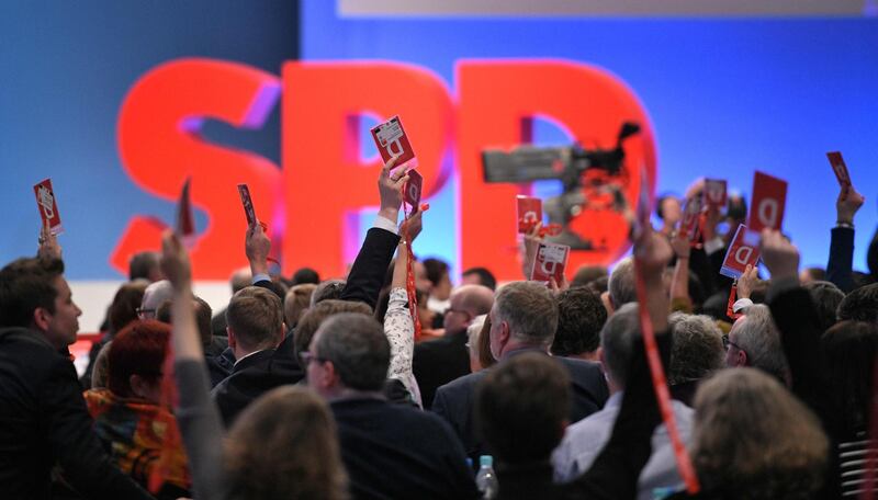 Delegates of Germany's social democratic SPD party hold up their voting cards during an extraordinary SPD party congress in Bonn, western Germany, on January 21, 2018.
Germany's divided Social Democrats hold a crunch vote on whether to pursue a coalition deal with German Chancellor Angela Merkel's conservatives, or plunge the nation into political turmoil. At the extraordinary congress, 600 delegates from the centre-left SPD and its 45-member board have their say on entering into formal talks for a renewed alliance with Merkel's centre-right CDU/CSU bloc.
 / AFP PHOTO / SASCHA SCHUERMANN