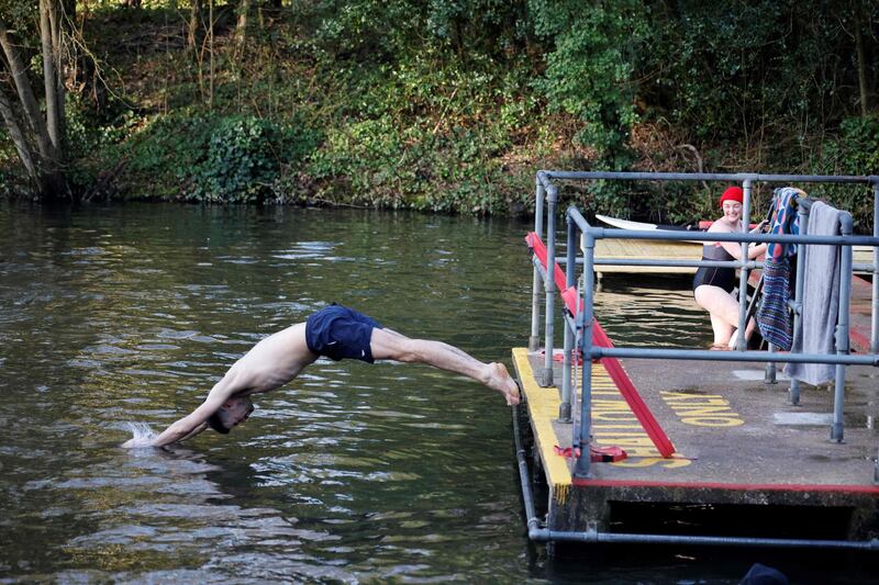 A swimmer enters the water at the Hampstead Heath ponds in London. AFP