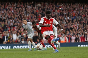 Arsenal's English midfielder Bukayo Saka scores the team's third goal from the penalty spot during the English Premier League football match between Arsenal and Liverpool at the Emirates Stadium in London on October 9, 2022.  (Photo by ADRIAN DENNIS / AFP) / RESTRICTED TO EDITORIAL USE.  No use with unauthorized audio, video, data, fixture lists, club/league logos or 'live' services.  Online in-match use limited to 120 images.  An additional 40 images may be used in extra time.  No video emulation.  Social media in-match use limited to 120 images.  An additional 40 images may be used in extra time.  No use in betting publications, games or single club/league/player publications.   /  