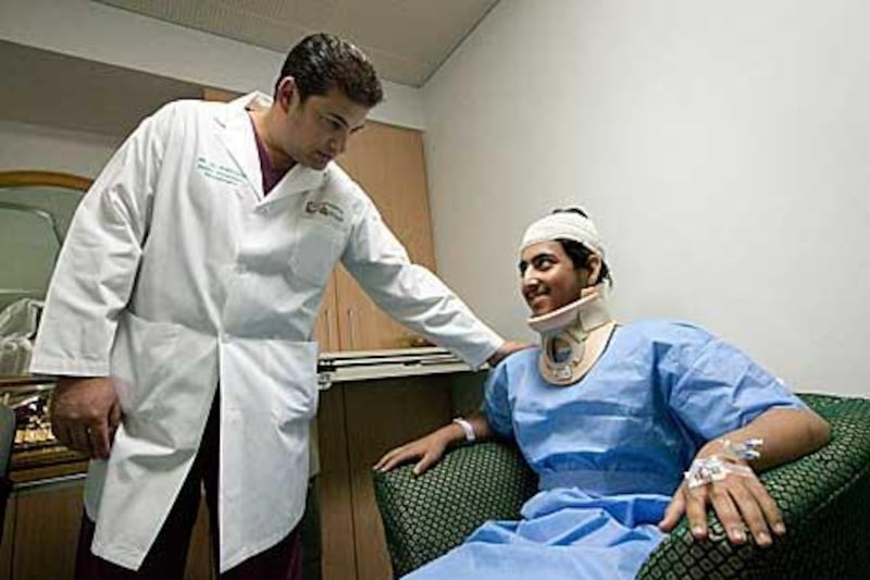 Dr Amr el Shawarby, the head of Tawam Hospital’s neurosurgery department, with his patient, 16-year-old  Abdullah Mubarak al Shamsi.