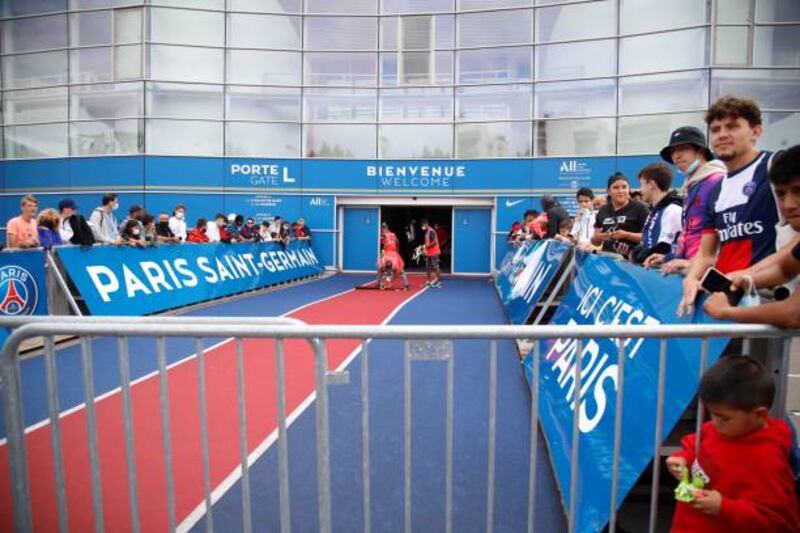 Supporters wait outside French football club Paris Saint-Germain's Parc des Princes stadium.