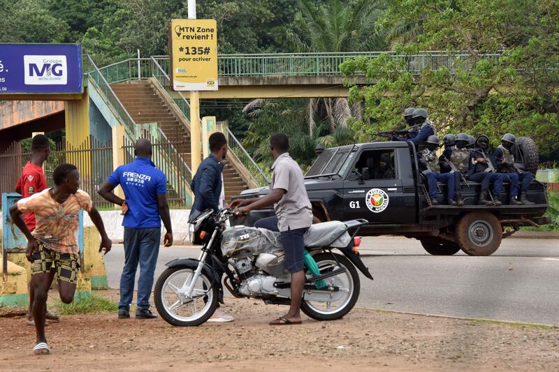 Guinean police drive through the central district of Kaloum, Conakry, after sustained gunfire in the capital. AFP