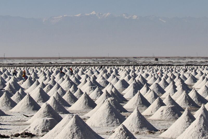 People work among piles of dried crude salt in Zhangye, Gansu, China. Reuters