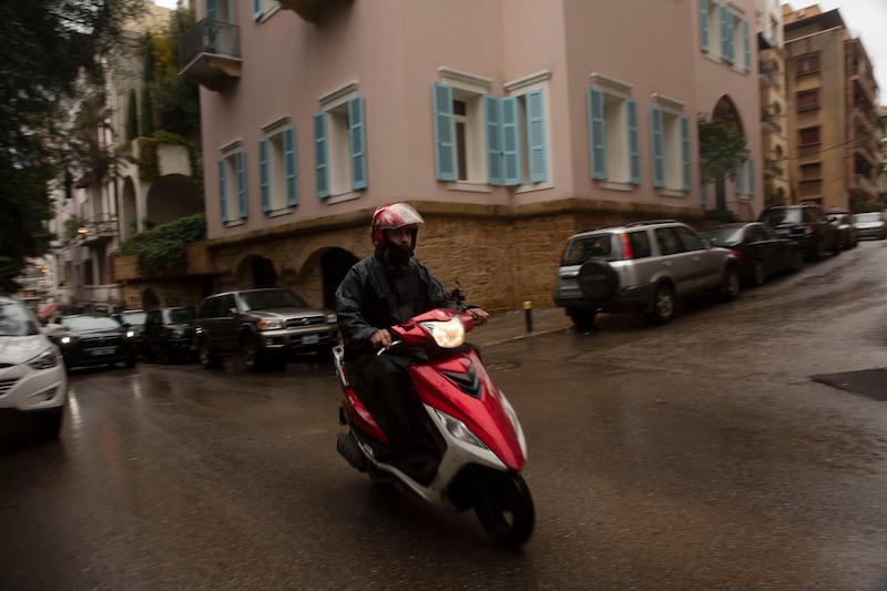 A man on a motorbike drives past the home of former Nissan Chairman Carlos Ghosn in Beirut, Lebanon, Thursday, January 2, 2020. AP