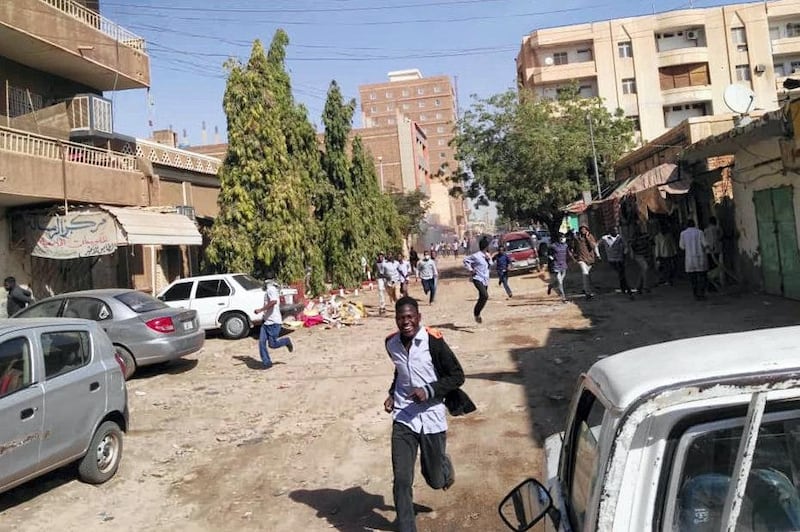 Sudanese protesters run away from tear gas smokes during a demonstration in Khartoum, on December 31, 2018. - Police fired tear gas at protesters in Sudan's capital on December 31 ahead of a planned march on President Omar al-Bashir's palace calling on him to "step down" following deadly anti-government protests. (Photo by - / AFP)