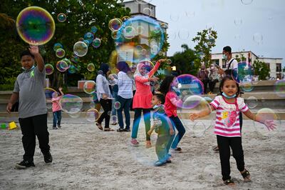 Local residents play with bubbles at Pantai Cenang in Langkawi on September 15. AFP