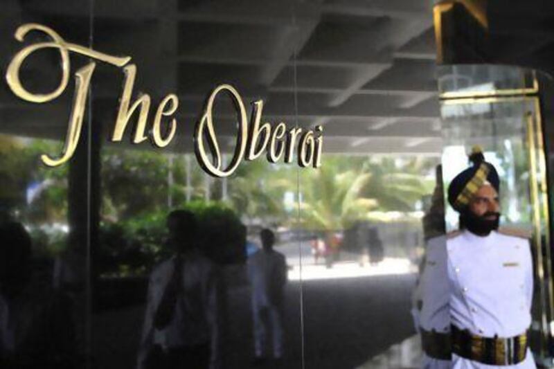 An attendant stands outside The Oberoi in Mumbai. India's luxury hotel chain is "actively looking at opportunities in Abu Dhabi". Sajjad Hussain / AFP