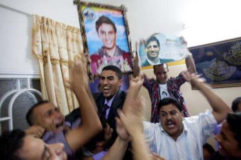 Shadi Assaf (centre), the brother of Mohammed Assaf, celebrates with family and friends at the Assaf home in the Khan Younis refugee camp in Gaza.  Heidi Levine / Sipa Press