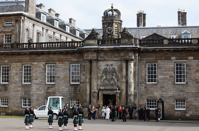 Queen Elizabeth and Pope Benedict XVI leave the Palace of Holyroodhouse, the Queen's official residence in Scotland, after a visit by the pope in 2010.