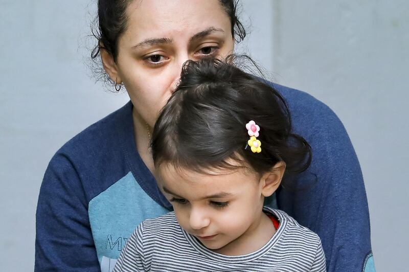 In this photo released by the Armenian Foreign Ministry, a woman with her child sit in a bombshelter to protect against shelling, in Stepanakert, the self-proclaimed Republic of Nagorno-Karabakh, Azerbaijan. AP