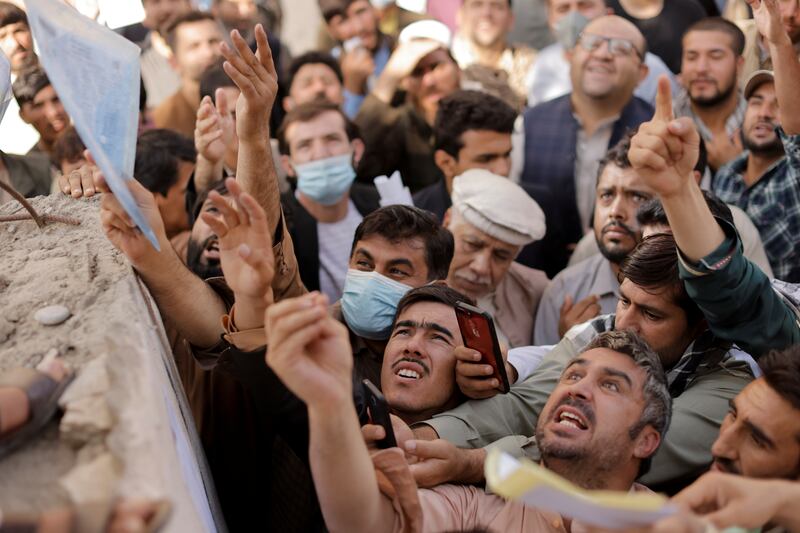Afghans gather outside the passport office in Kabul. Photo: Reuters