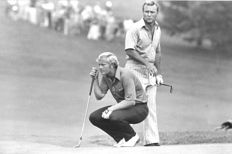 This July 31, 1972, file photo shows Jack Nicklaus kneeling as partner Arnold Palmer looks over his shoulder while they study a putt on 18th green at Laurel Valley Golf Club at the PGA National Team Championship in Ligonier, Pennsylvania. AP Photo