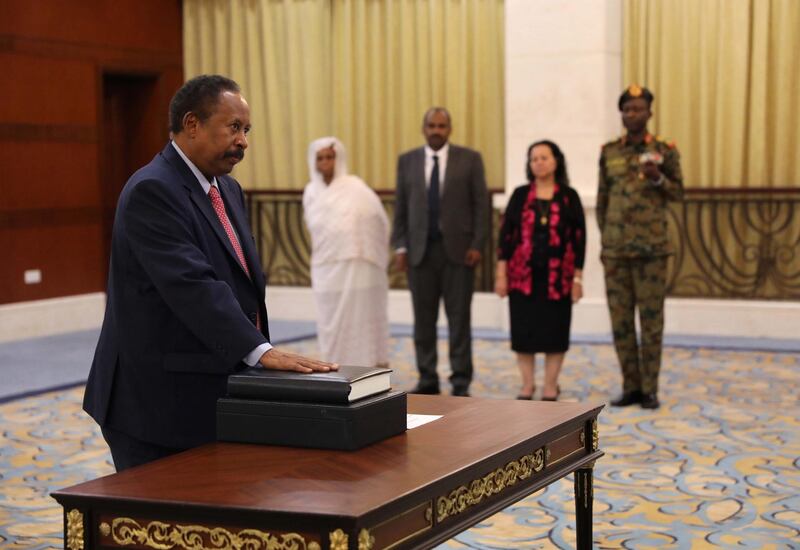 epa07784904 Sudan's new Prime Minister Abdalla Hamdok (L) swears in during a ceremony at the presidential palace in Khartoum, Sudan, 21 August 2019. The Sudanese opposition and military council signed on 17 August a power sharing agreement. The agreement sets up a sovereign council made of five generals and six civilians, to rule the country until general elections. Protests had erupted in Sudan in December 2018, culminating in a long sit-in outside the army headquarters which ended with more than one hundred people being killed and others injured. Sudanese President Omar Hassan al-Bashir stepped down on 11 April 2019.  EPA/MARWAN ALI