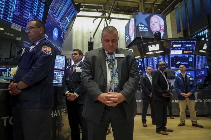 NEW YORK, NY - AUGUST 27: Traders and financial professionals observe a moment of silence for the late U.S. Senator John McCain prior to the opening bell on the floor of the New York Stock Exchange (NYSE), August 27, 2018 in New York City. McCain passed away on August 25 following a long battle with brain cancer.   Drew Angerer/Getty Images/AFP
== FOR NEWSPAPERS, INTERNET, TELCOS & TELEVISION USE ONLY ==
