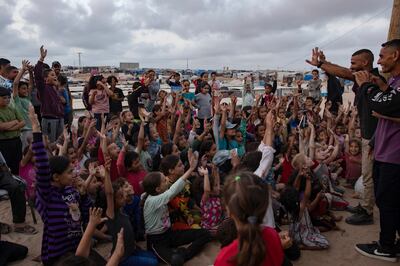 Children gather at a makeshift cinema in Rafah refugee camp, in southern Gaza. EPA