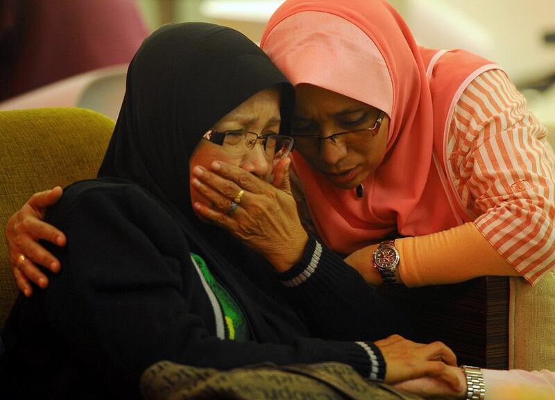 Family members of passengers aboard a missing plane cry at a hotel in Putrajaya, Malaysia. Joshua Paul