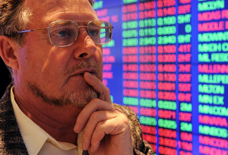 Investor Christopher Lusty watches stock price monitors at the Australian Stock Exchange (ASX) in Sydney on August 5, 2011. Treasurer Wayne Swan insisted Australia could weather the global economic storm as stocks plunged four percent, down 171 points to finish at 4,105.4, following carnage on US and European markets.  AFP PHOTO / Torsten BLACKWOOD
 *** Local Caption ***  555341-01-08.jpg