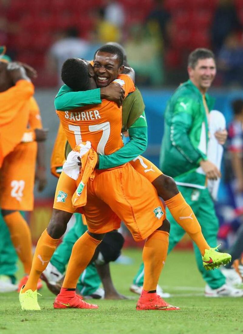 Serge Aurier and Jean-Daniel Akpa-Akpro embrace after securing their Group C win against Japan. Julian Finney / Getty Images