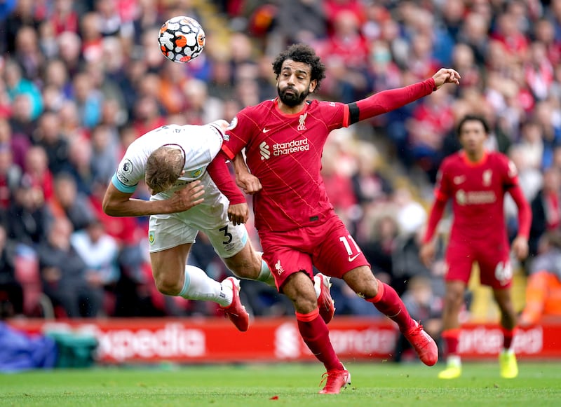 Liverpool's Mohamed Salah and Charlie Taylor of Burnley battle for a header. PA