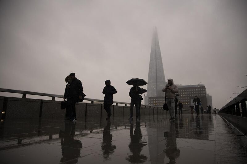 Commuters cross London Bridge in the City of London, U.K., on Monday, Feb. 15, 2021. The U.K. recorded 15 million vaccinations against the coronavirus, a milestone that is set to increase pressure on Prime Minister Boris Johnson to begin reopening the economy. Photographer: Jason Alden/Bloomberg