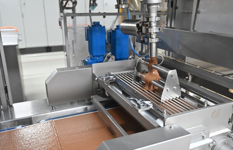 The chocolate praline mixture is lain over the wafers before they are stacked.