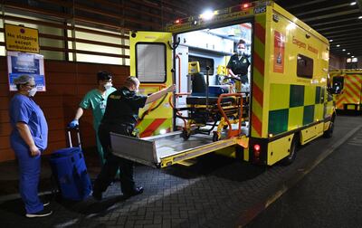 epa08934249 NHS staff stand outside the Royal London hospital in London, Britain, 13 January 2021. Britain's national health service (NHS) is coming under sever pressure as COVID-19 disease related hospital admissions continue to rise across the UK.  EPA/ANDY RAIN