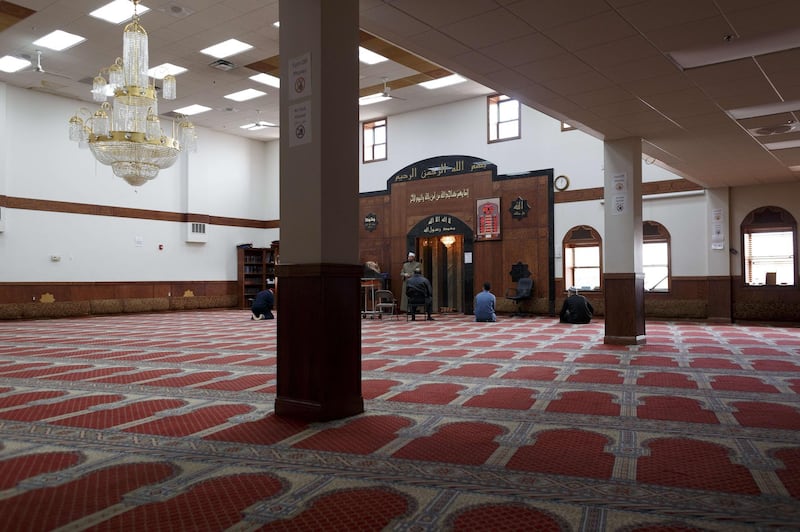 Imam Magdy Badr leads prayers over a live broadcast on a laptop in a nearly empty room at Masjid Al Salaam mosque on the first full day of Ramada on April 24, 2020 in Dearborn, Michigan. Getty Images via AFP