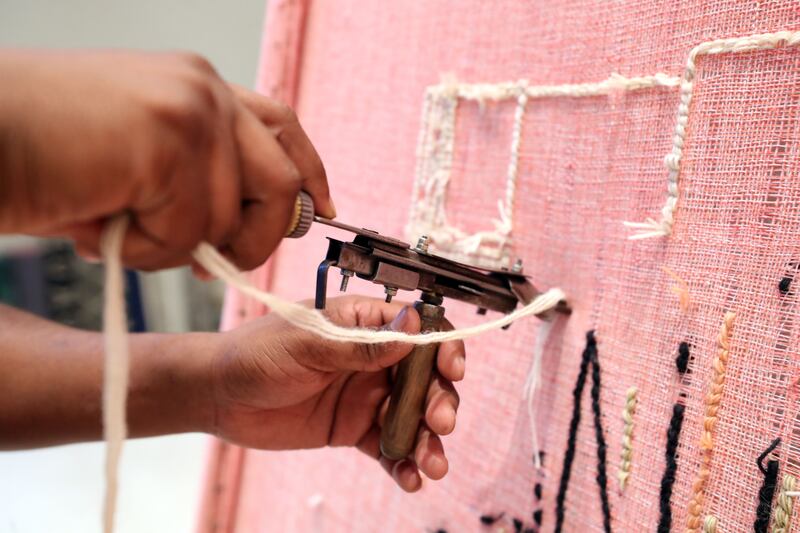 A close-up of the hand tufting technique 