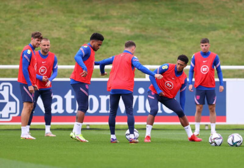 Jude Bellingham, second right, attempts to win the ball during training. Getty