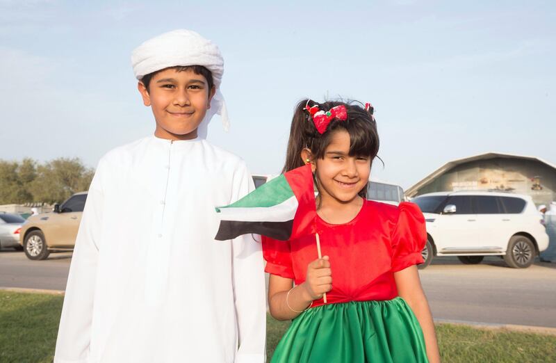 FUJAIRAH, UNITED ARAB EMIRATES - Sibling Hashil and Rayan Al Zayudi with their UAE inspired dress watching from the street of  the Fourth Union Fortress, Fujairah.  Leslie Pableo for The National for Ruba Haza���s story