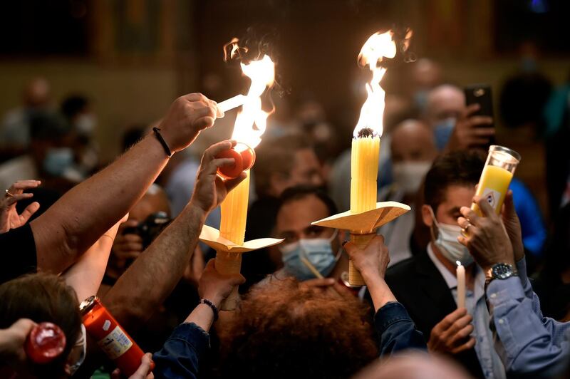 Greek Orthodox Christians light candles with the Holy Fire at Saint George Greek Orthodox Cathedral in central Beirut, Lebanon. EPA