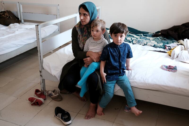 Morsal Mousavi, a 22-year-old Afghan woman, was caught by Turkish security forces after crossing into the country illegally from Iran, and is pictured with her children at a migrant processing centre in the border city of Van. They are just some of thousands of people who have fled Afghanistan since the Taliban takeover. Reuters