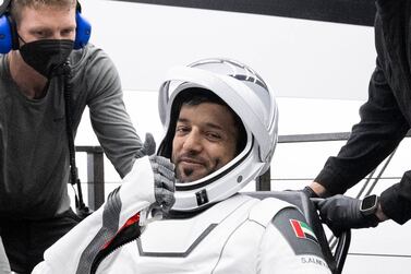 In this photo provided by NASA, United Arab Emirates astronaut Sultan al-Neyadi gestures as he is helped out of a SpaceX capsule onboard a recovery ship after he and NASA astronauts Warren "Woody" Hoburg, Stephen Bowen, and Roscosmos cosmonaut Andrei Fedyaev landed in the Atlantic Ocean off the Florida coast, Monday, Sept.  4, 2023.  The astronauts are back on Earth after a six-month stay at the International Space Station.  (Joel Kowsky / NASA via AP)