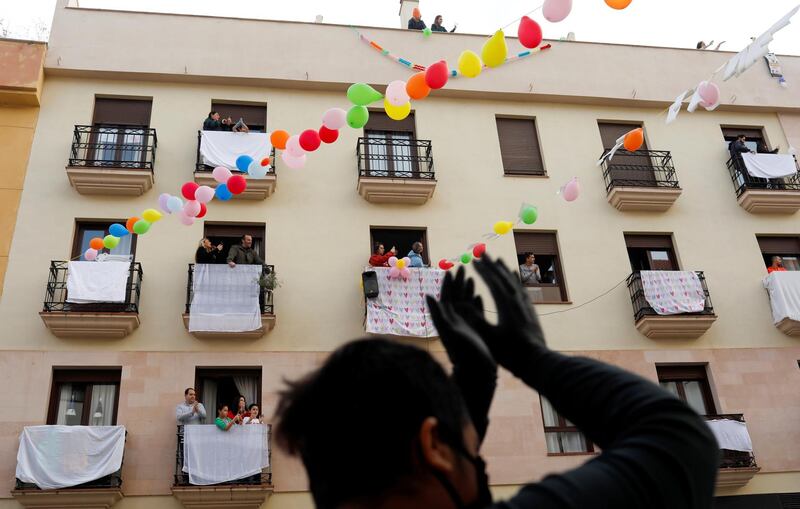 Neighbours celebrate the engagement of Juan Manuel Zamorano, 32, and Elena Gonzalez, 31, after she proposed to him at the balcony of their house in downtown Ronda, southern Spain. Reuters
