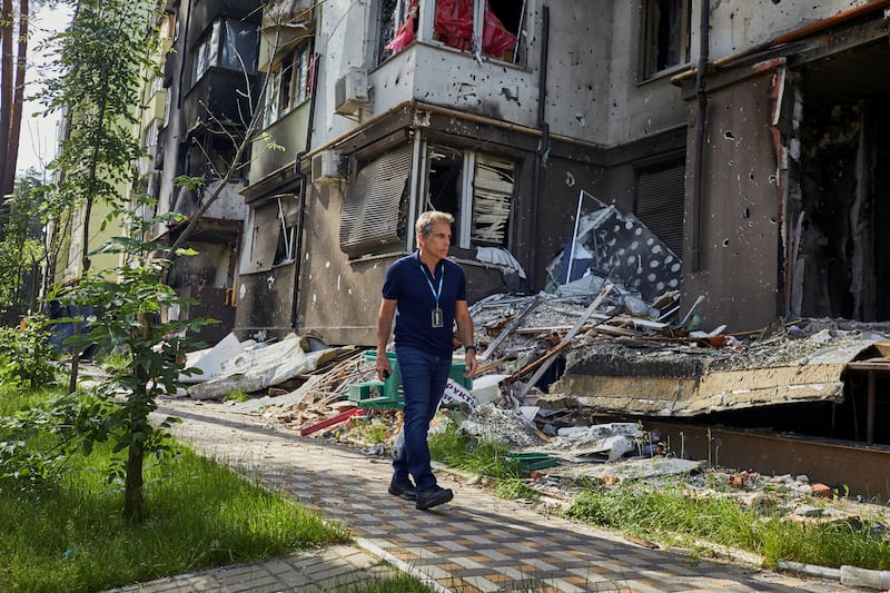 Stiller walks past a damaged building as he visits the Lypki neighbourhood in Irpin, Ukraine. Reuters