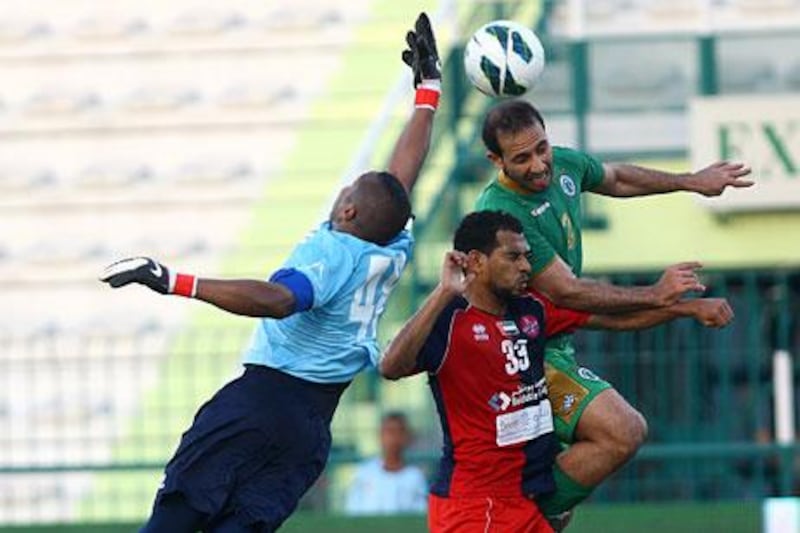 Mutaz Abdullah, left, and Eissa Ahmad, centre, and their Al Shaab teammates played an Al Shabab side that rested most of its regulars but who still put a fight in a 2-1 win that kept Al Shaab from relegation.