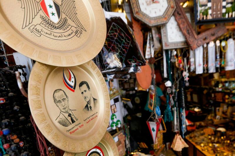 Souvenir plates bearing the Syrian flag and the portraits of Russian President Vladimir Putin and Syrian President Bashar Al Assad are pictured in a shop in a bazaar in old Damascus. AFP