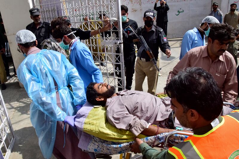 Paramedics and volunteers carry a blast victim on a stretcher into a hospital in Quetta after a suicide bombing in Mastung, Pakistan. AP