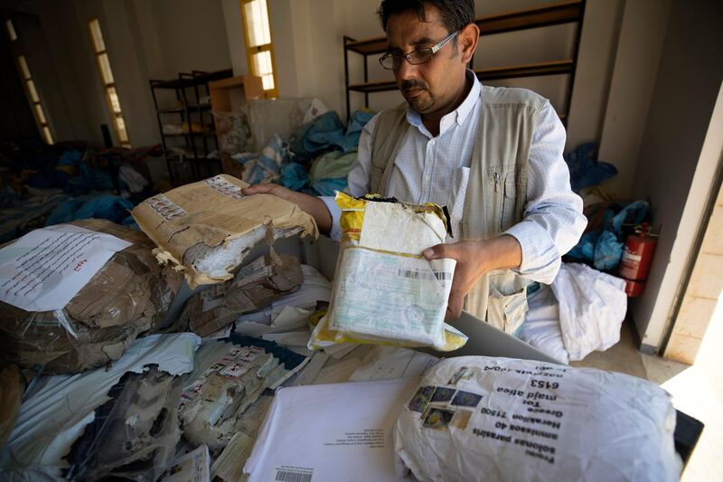 epa06952404 A Palestinian employee sorts undelivered mail  at the Palestinian central international exchange post office in the West Bank city of Jericho, 16 August 2018. Earlier on the same week Israel released 10 tonnes of undelivered mail dating as far as 2010, it included packages, letters, and internet orders intended for Palestinians in the West Bank, Gaza, and Jerusalem.  EPA/ATEF SAFADI