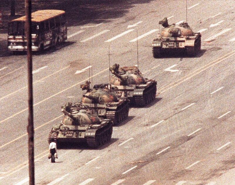 A man stands in front of a convoy of tanks in the Avenue of Eternal Peace in Tiananmen Square in Beijing on June 5, 1989. Arthur Tsang / Reuters