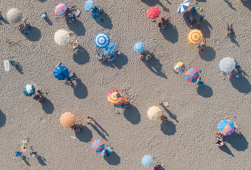 An aerial view taken with a drone shows people on a beach in Guzelcamli district in Aydin, Turkey. EPA