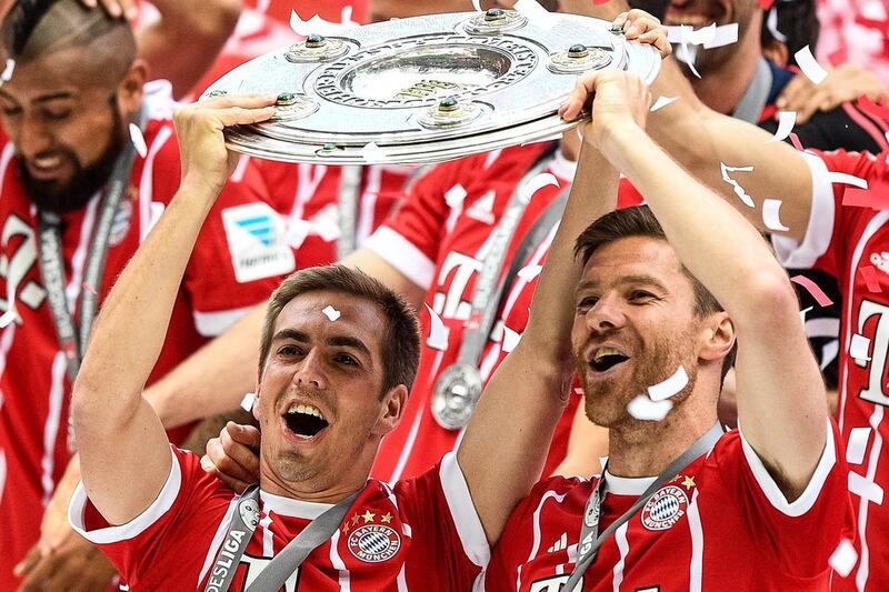 Philipp Lahm, left, and Xabi Alonso, lift the Bundesliga shield after Bayern Munich defeated Freiburg in Munich, Germany on Saturday, May 20, 2017. The pair will now retire from football. Christian Bruna / EPA