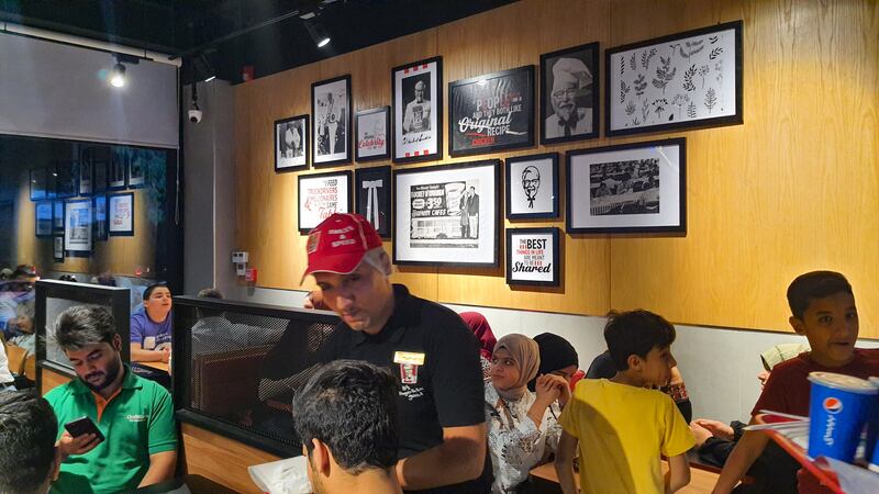 Adorned with pictures of KFC's founder, the restaurant creates a lively and welcoming atmosphere
